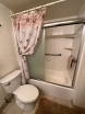 Upgraded master bathroom, tiled vanity top, new tiled shower over tub, flooring and glass door enclosure