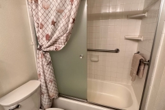Upgraded master bathroom, tiled vanity top, new tiled shower over tub, flooring and glass door enclosure
