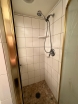 All new shower, custom etched window, tiled vanity top and floor